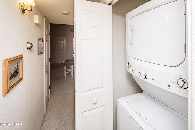 laundry area featuring stacked washer and clothes dryer