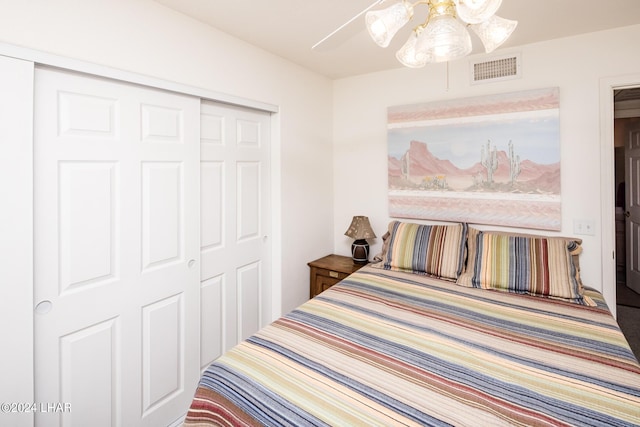 bedroom with ceiling fan and a closet