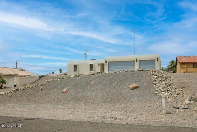 view of front of property featuring a garage and stucco siding