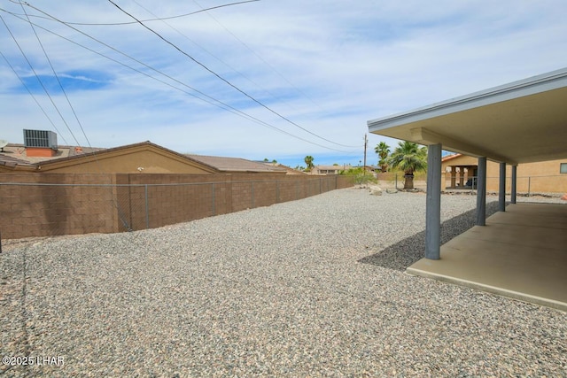 view of yard featuring a fenced backyard, cooling unit, and a patio area