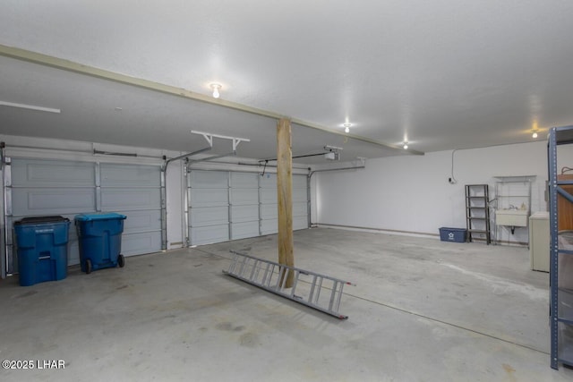 garage with a sink and a garage door opener