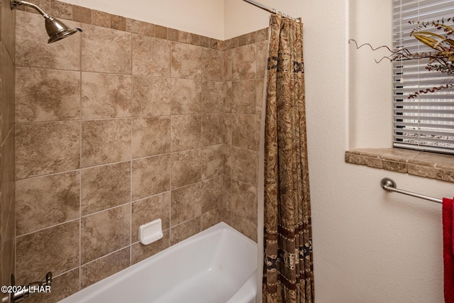 bathroom with shower / bath combination with curtain