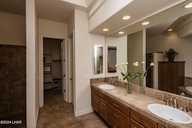 full bath with tile patterned floors, recessed lighting, double vanity, and a sink