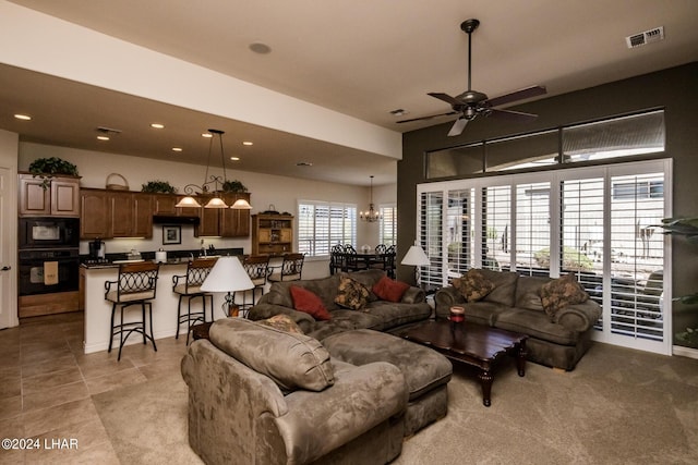 living room with light tile patterned floors, recessed lighting, visible vents, and ceiling fan