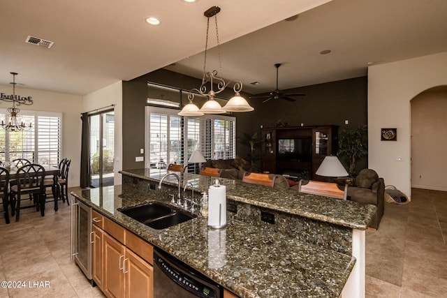 kitchen with a center island with sink, visible vents, a sink, black dishwasher, and open floor plan