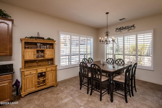 dining room with a chandelier, visible vents, plenty of natural light, and baseboards