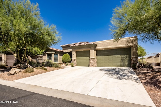 view of front of property with driveway, stucco siding, a garage, stone siding, and a tile roof