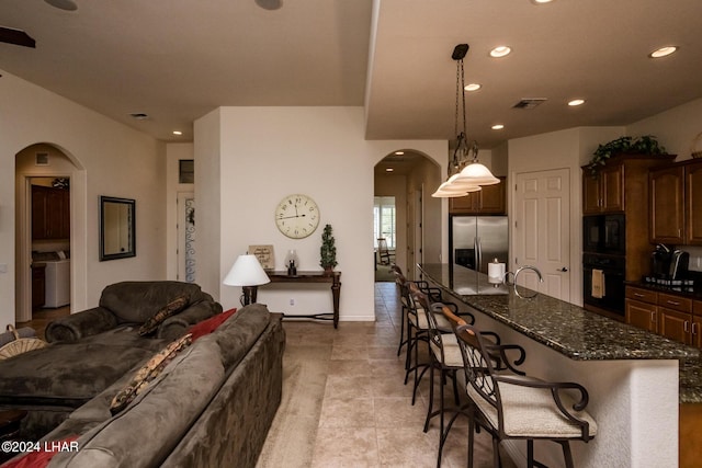 interior space featuring recessed lighting, visible vents, and arched walkways