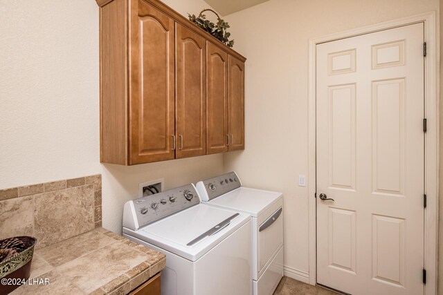 washroom with cabinet space and independent washer and dryer