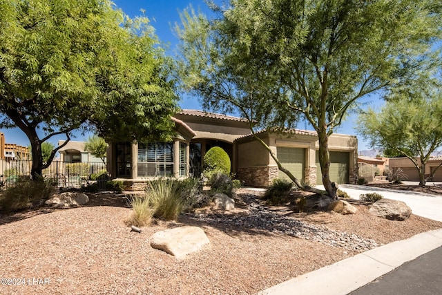 view of front of house featuring fence, an attached garage, concrete driveway, stone siding, and a tiled roof