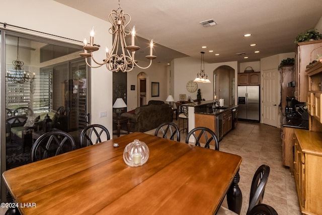 dining space with visible vents, an inviting chandelier, light tile patterned flooring, recessed lighting, and arched walkways