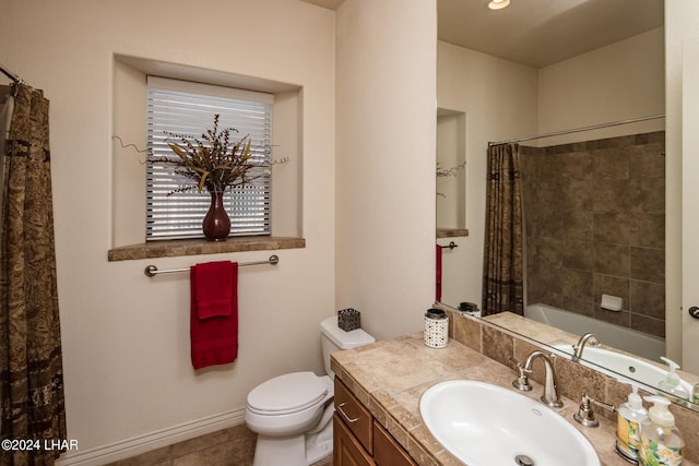 bathroom featuring toilet, vanity, and baseboards