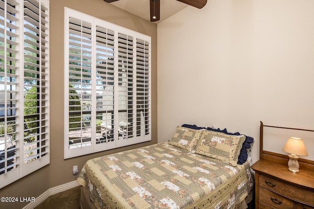 carpeted bedroom featuring a ceiling fan and baseboards