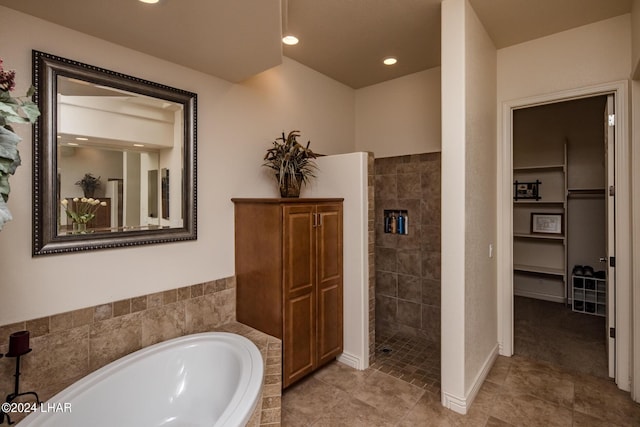 bathroom featuring a bath, tile patterned floors, recessed lighting, and a walk in shower