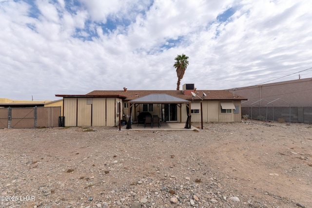 back of property featuring a gazebo, a patio area, and fence