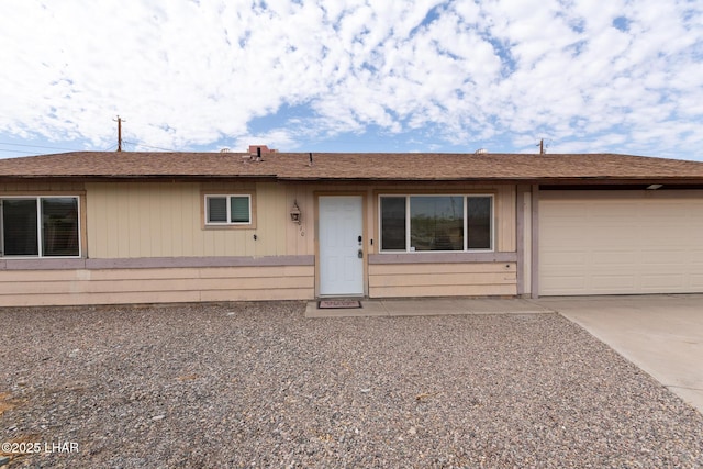 single story home featuring a garage and concrete driveway