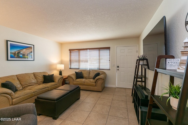 living area with light tile patterned flooring and a textured ceiling