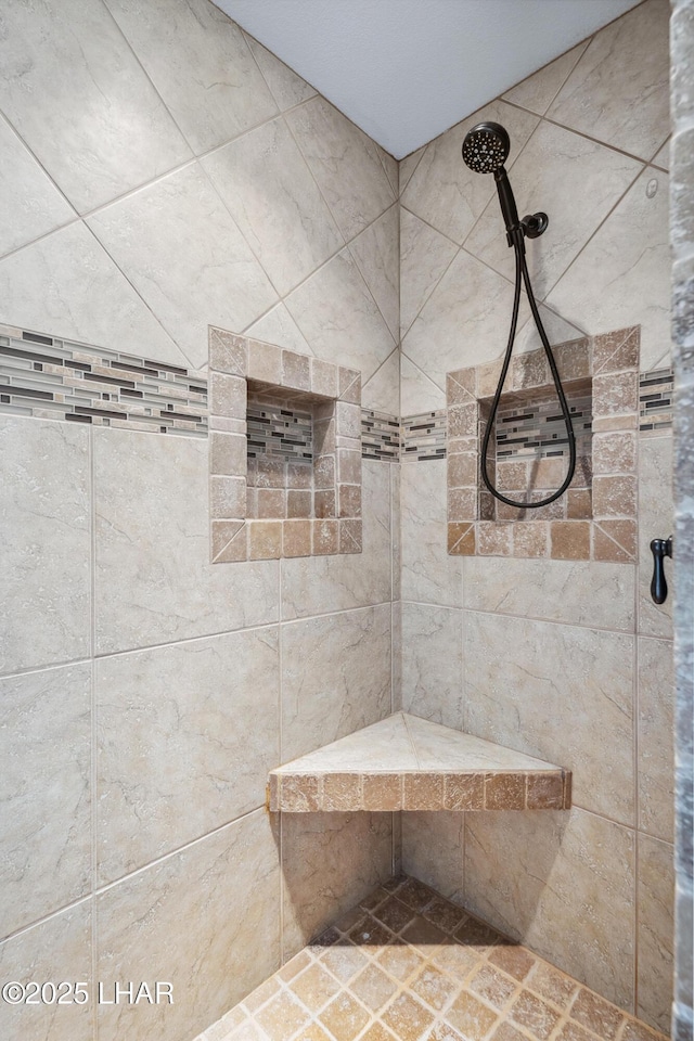 full bath with a tile shower