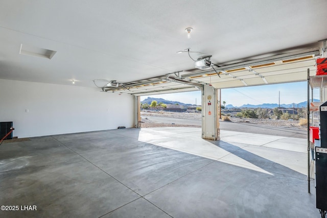 garage featuring a mountain view and a garage door opener