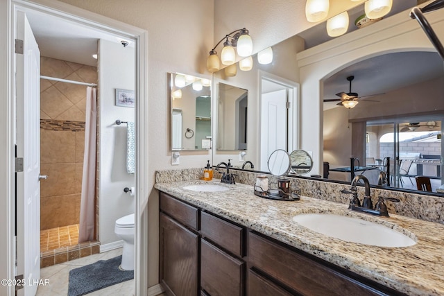 full bath featuring a shower stall, toilet, and a sink