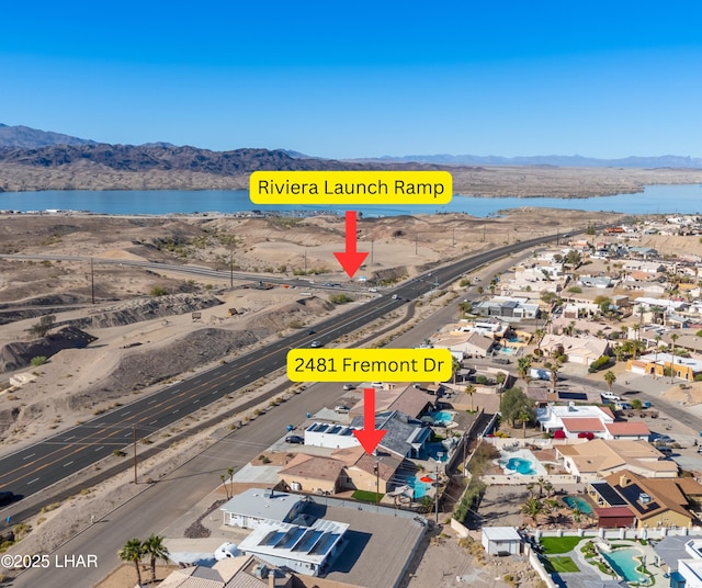 birds eye view of property with a residential view and a water and mountain view