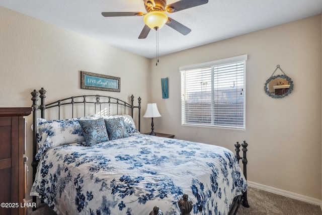 carpeted bedroom with a ceiling fan and baseboards