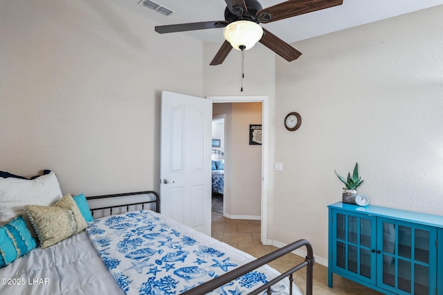 bedroom with light tile patterned floors, visible vents, ceiling fan, and baseboards