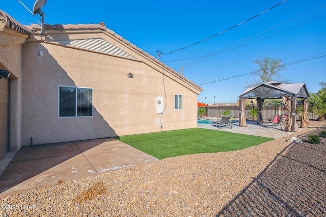 view of yard with a gazebo, a fenced backyard, a fenced in pool, and a patio