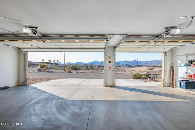 garage with a garage door opener and a mountain view