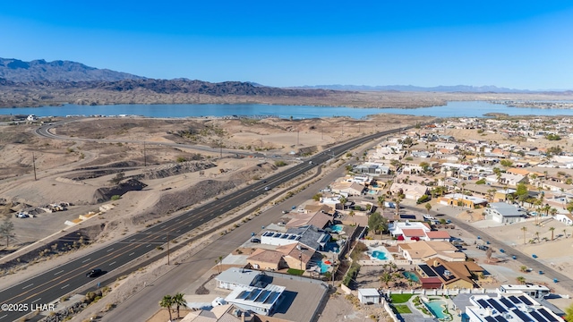 birds eye view of property featuring a water and mountain view