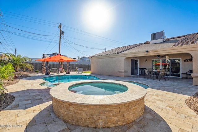 view of pool with a patio, central AC unit, an in ground hot tub, outdoor dining area, and fence private yard