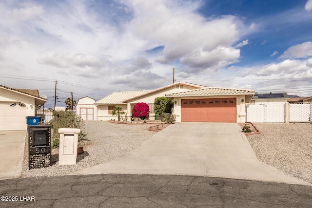 ranch-style home with stucco siding, concrete driveway, an attached garage, fence, and a tiled roof