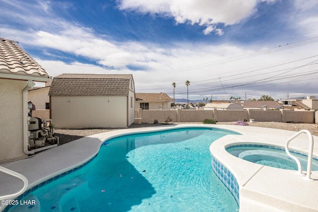 view of pool with a pool with connected hot tub, a fenced backyard, an outdoor structure, and a storage shed