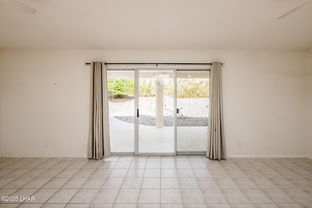 unfurnished room featuring light tile patterned floors and baseboards