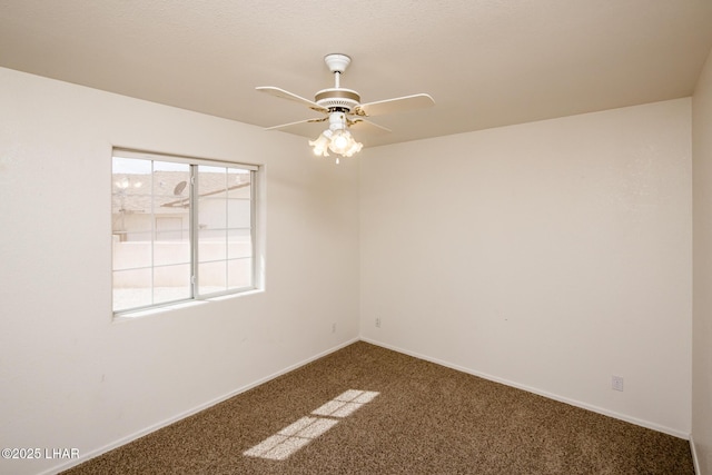 spare room with carpet flooring, a ceiling fan, and baseboards