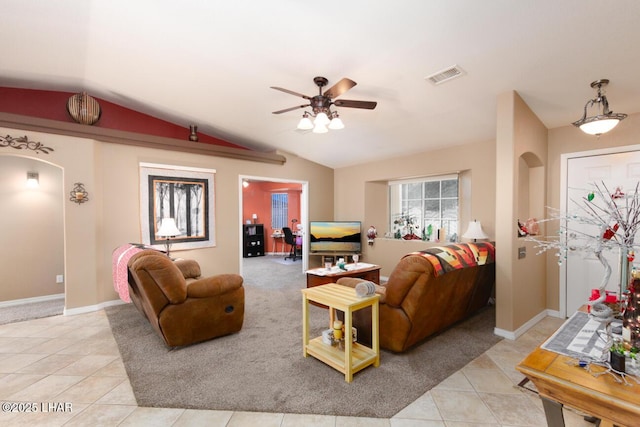 tiled living room featuring ceiling fan and lofted ceiling