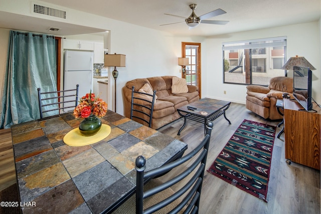 500 S Lake Havasu Ave N Unit A12, Lake Havasu City, AZ 86403 - living area featuring baseboards, wood finished floors, visible vents, and ceiling fan