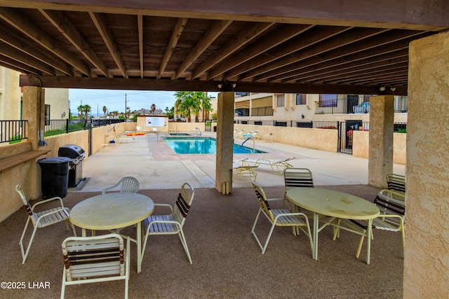 500 S Lake Havasu Ave N Unit A12, Lake Havasu City, AZ 86403 - view of patio / terrace featuring a fenced backyard, a community pool, a storage unit, and grilling area