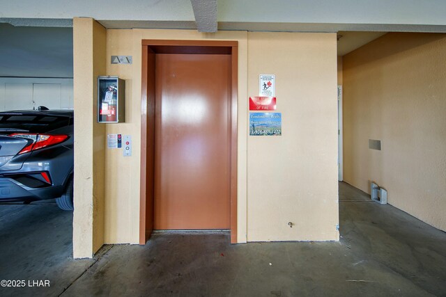 500 S Lake Havasu Ave N Unit A12, Lake Havasu City, AZ 86403 - hallway featuring elevator and unfinished concrete flooring