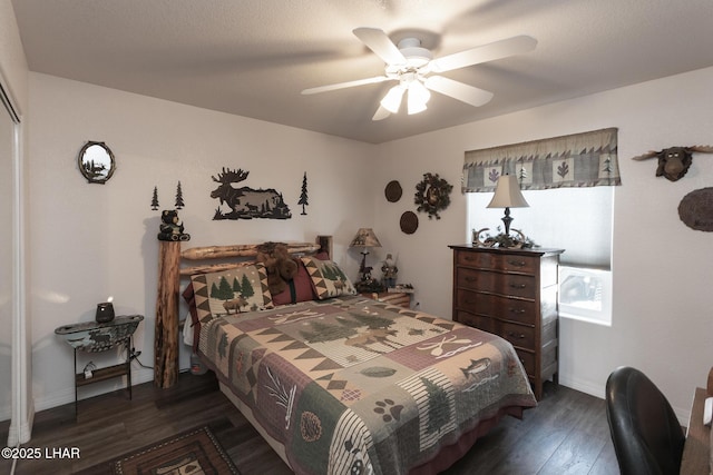 bedroom with ceiling fan, baseboards, and dark wood-style flooring