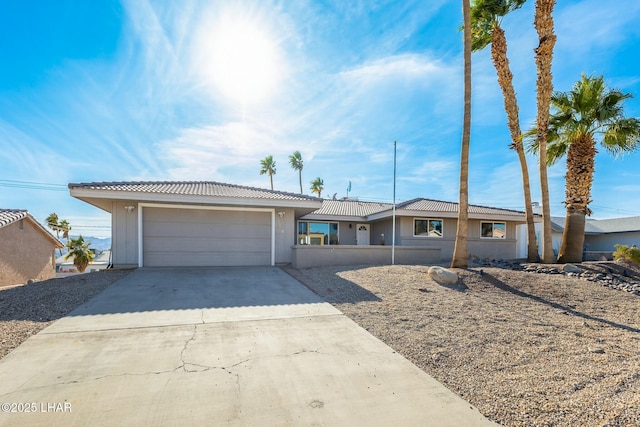 ranch-style home featuring an attached garage and driveway