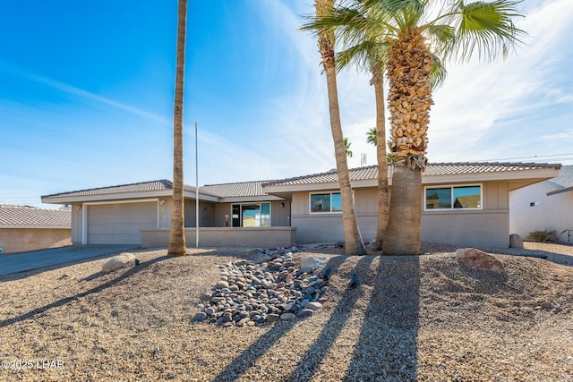 view of front of property featuring an attached garage and concrete driveway