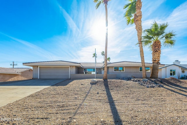 single story home featuring an attached garage and driveway