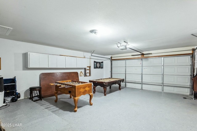 garage featuring visible vents and a garage door opener