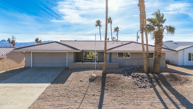 single story home featuring driveway, an attached garage, and stucco siding