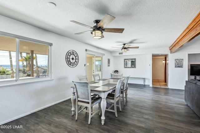 dining room featuring dark wood-style floors, a textured ceiling, and baseboards