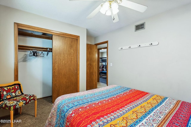 bedroom with a ceiling fan, visible vents, a closet, and carpet flooring