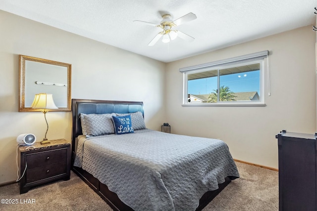 bedroom featuring ceiling fan, baseboards, a textured ceiling, and light colored carpet