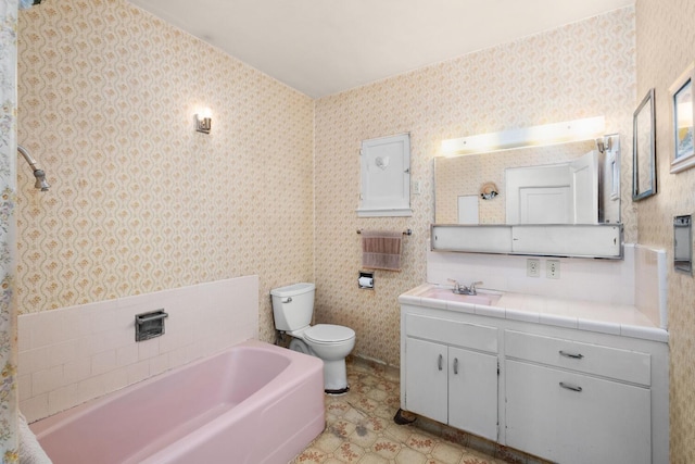 bathroom with a washtub, toilet, tile patterned floors, and vanity