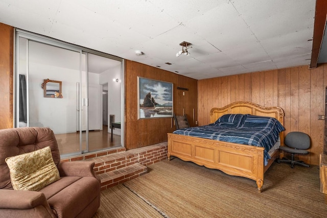 bedroom featuring wood walls